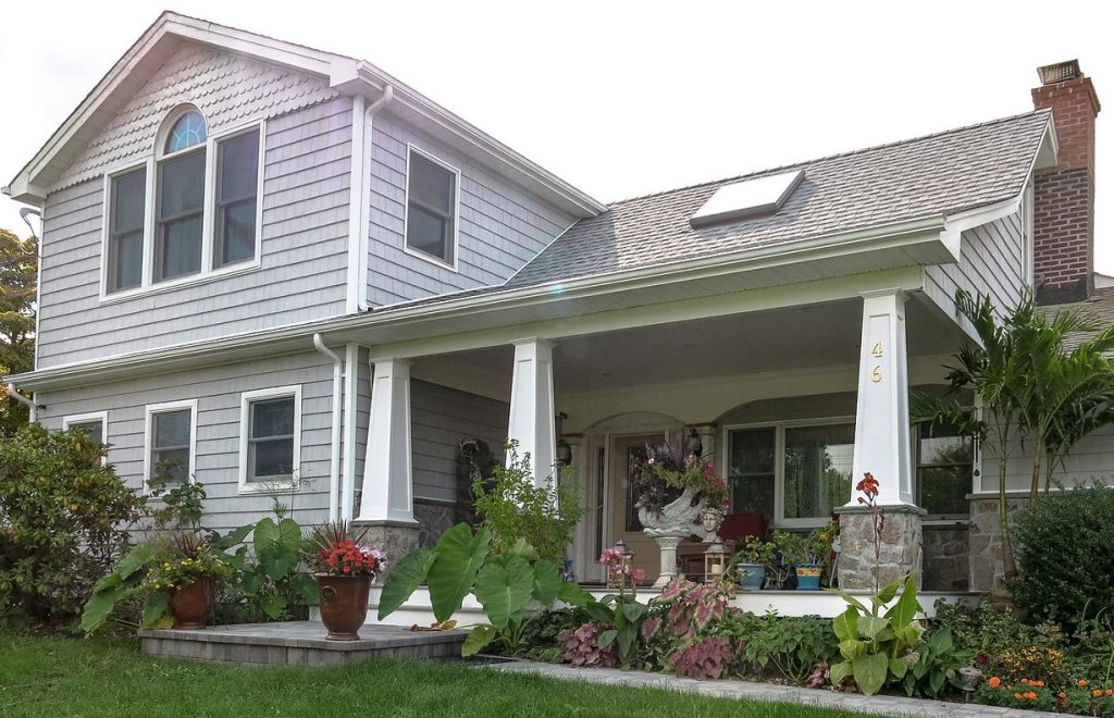 Reconstructed house exterior by Kammerer Inc Constructions, featuring modern architectural design with a spacious front porch and large windows